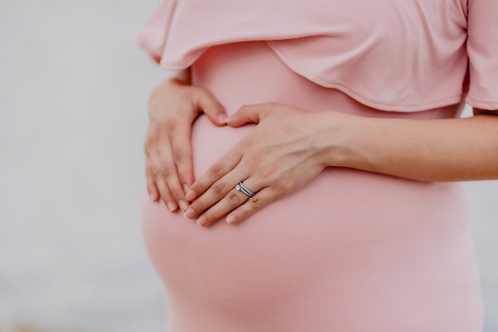 woman holding her pregnant belly
